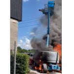 man about to leap from a burning boom lift