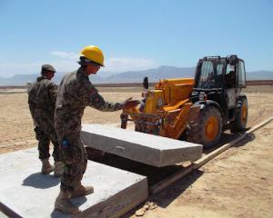 two people guiding a forklift carrying precast concrete heavy equipment training 